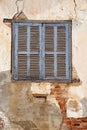 Old Shuttered Window In Cracked Peeling Wall