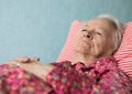 Old sick woman lying in bed Royalty Free Stock Photo