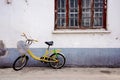 Old side street with a vintage old yellow bike Royalty Free Stock Photo