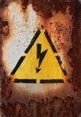 Old sign of danger of electric shock covered with rust Royalty Free Stock Photo