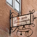 Old sign in forging art depicting a scale from 1777 in the center of Haderslev