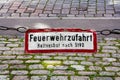 Old sign labeled with the German words Feuerwehrzufahrt, Haltverbot nach StVO (fire rescue path, halt banned by highway code) han Royalty Free Stock Photo