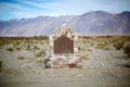 Old signboard with stone surround in Death Valley