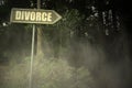 Old signboard with text divorce near the sinister forest Royalty Free Stock Photo