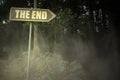 Old signboard with text the end near the sinister forest