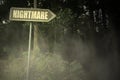 Old signboard with text nightmare near the sinister forest Royalty Free Stock Photo