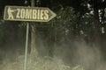 Old signboard with text zombies near the sinister forest