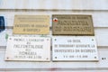 Old signs on the University of Bucharest showing different areas of the Faculty of Geography