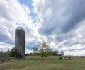 Old silo in open field surrounded by grass Royalty Free Stock Photo