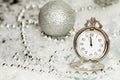 Old silver clock close to midnight and Christmas decorations