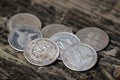 Old silver coins as souvenirs on wooden table Royalty Free Stock Photo