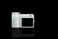 Old silver compact digital camera on black background. Royalty Free Stock Photo