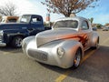 Old silver gray 1941 Willys Overland Americar coupe hot rod in a parking lot. Classic car show.