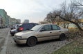 Old silver grey veteran classic rusty sedan car Nissan Almera parked