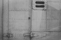 Old silver metal surface of the aircraft fuselage with rivets. Fuselage detail view. Airplane metallic fuselage detail