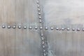 Old silver metal surface of the aircraft fuselage with rivets. Iron plate,steel sheet texture,pattern and background. Royalty Free Stock Photo