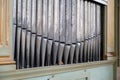 Old, silver organ pipes in a church used for playing sacred music. Many air pipes, sound tubes in the cathedral