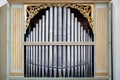 Old, silver organ pipes in a church used for playing sacred music. Many air pipes, sound tubes in the cathedral Royalty Free Stock Photo