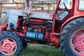 Old silver painted diesel tank on red vintage russian tractor engine visible wiring rust and oil drops on sunny autumn Royalty Free Stock Photo