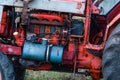 Old silver painted diesel tank on red vintage russian tractor engine visible wiring rust and oil drops on sunny autumn Royalty Free Stock Photo