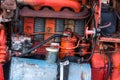 Old silver painted diesel tank on red vintage russian tractor engine visible wiring rust and oil drops on sunny autumn Royalty Free Stock Photo