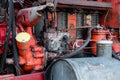 Old silver painted diesel tank on red vintage russian tractor engine visible wiring rust and oil drops on sunny autumn day in Royalty Free Stock Photo