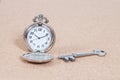 Old silver pocket watch and key Royalty Free Stock Photo