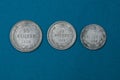 old silver soviet coins lying on a blue table