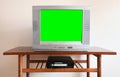 Old silver vintage TV with clutter from 1980s, 1990s, 2000s, VCR on wallpaper background. Royalty Free Stock Photo