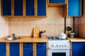 Old simple kitchen interior design with ugly messy cabinets in need of remodel Royalty Free Stock Photo