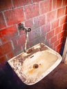 Old sink in a public abandoned restroom Royalty Free Stock Photo