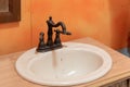 Old sink with vintage faucet in a bathroom of abandoned house Royalty Free Stock Photo