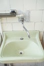 old sink washstand in a bathroom with white tiles. Royalty Free Stock Photo