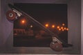 Old skateboard leaning on the wall in an urban area at night Royalty Free Stock Photo