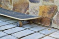 Old skateboard from a stone wall Royalty Free Stock Photo