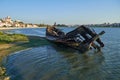 Old skeleton of a destroyed and burned boat on the bank of the S