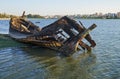 Old skeleton of a destroyed and burned boat on the bank of the Seixal Bay. Lisbon. Portugal