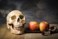 Old skull and fruit still life on wooden board