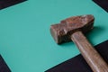 Old sledgehammer on a turquoise background Royalty Free Stock Photo