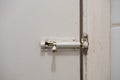 Old slide lock on dirty door Royalty Free Stock Photo