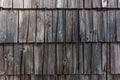 Old slovenian mountain cottage tiled wooden facade, worn wood tiles on exterior wall Royalty Free Stock Photo