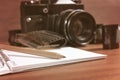 Old SLR camera on the table next to negative film strip, and in Royalty Free Stock Photo