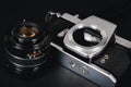 Old SLR film camera and a lens on black background, Photography Concept Royalty Free Stock Photo