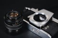 Old SLR film camera and a lens on black background, Photography Concept Royalty Free Stock Photo