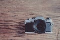 Old SLR Film camera on wood background