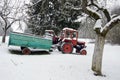 Old small agriculture tractor in winter farm garden Royalty Free Stock Photo