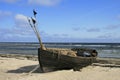 Old small boat lying on the beach Royalty Free Stock Photo