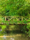 Old small bridge over river in green garden. Royalty Free Stock Photo