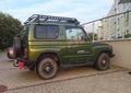 Old small classic vintage green offroad 4WD car Kia parked