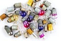 Old small colored light bulbs on a white background Royalty Free Stock Photo
